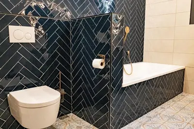 a bathroom with a toilet and a sink and a tub at Le chant des jardins in LʼIsle-sur-la-Sorgue