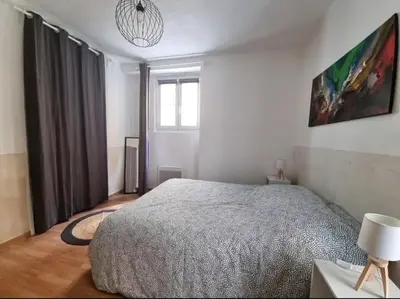 a bedroom with a large bed and a window at Appartement centre historique in Aix-en-Provence