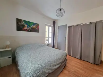a bedroom with a bed and a window in it at Appartement centre historique in Aix-en-Provence