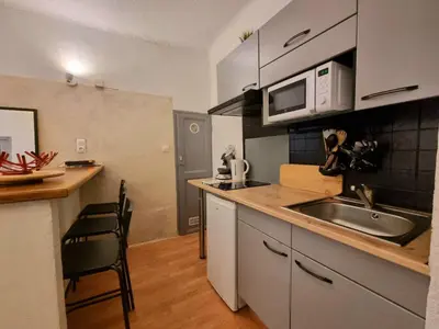 a small kitchen with a sink and a microwave at Appartement centre historique in Aix-en-Provence