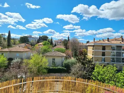a view of a city from a fence at Appartement spacieux de standing - parking gratuit in Aix-en-Provence