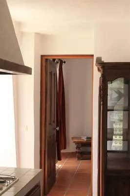 a kitchen with a door open to a room at L' ABBADIE in Carniol