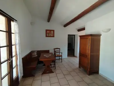 a room with a table and chairs in a room at L' ABBADIE in Carniol