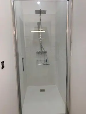 a shower with a glass door in a bathroom at Studio climatisé et tout équipé in Saint-Didier
