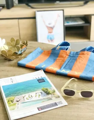 a table with a towel and a pair of glasses and a magazine at Superb Apartment - Downtown Aix-en-Provence in Aix-en-Provence
