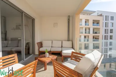 a balcony with chairs and a couch on a balcony at Superb Apartment - Downtown Aix-en-Provence in Aix-en-Provence