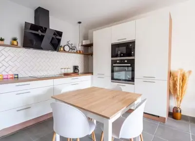 a kitchen with white cabinets and a wooden table and white chairs at Superb Apartment - Downtown Aix-en-Provence in Aix-en-Provence