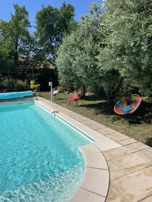 a swimming pool with two lawn chairs and trees at Magnifique villa -piscine privée vue Mont Ventoux in Malemort-du-Comtat