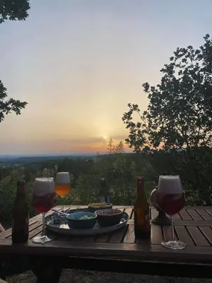 a table with glasses of wine and a plate of food at Magnifique villa -piscine privée vue Mont Ventoux in Malemort-du-Comtat