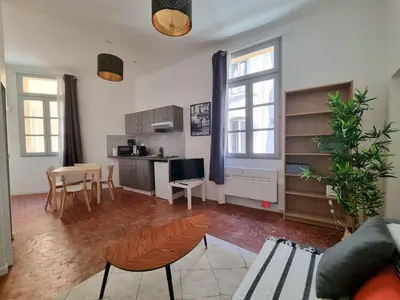 a living room with a kitchen and a dining room at Studio centre historique 1 in Aix-en-Provence