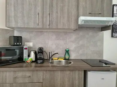a kitchen counter with a sink and a microwave at Studio centre historique 1 in Aix-en-Provence