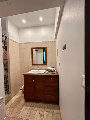 a bathroom with a sink and a mirror at UN MOMENT SUSPENDU in Aix-en-Provence